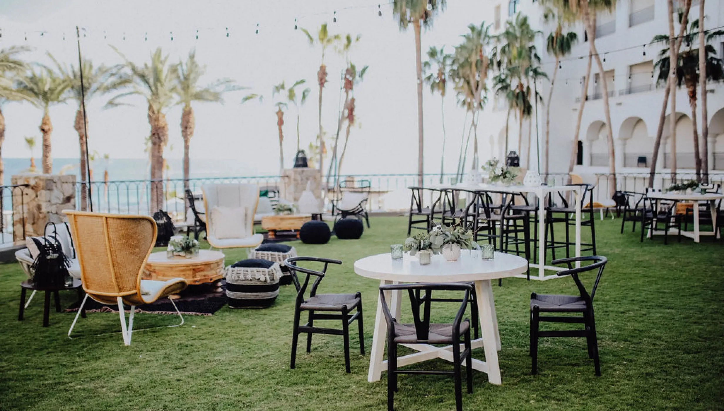 Outdoor cocktail hour lounge and seating on the lawn at Hilton Los Cabos, Cabo San Lucas