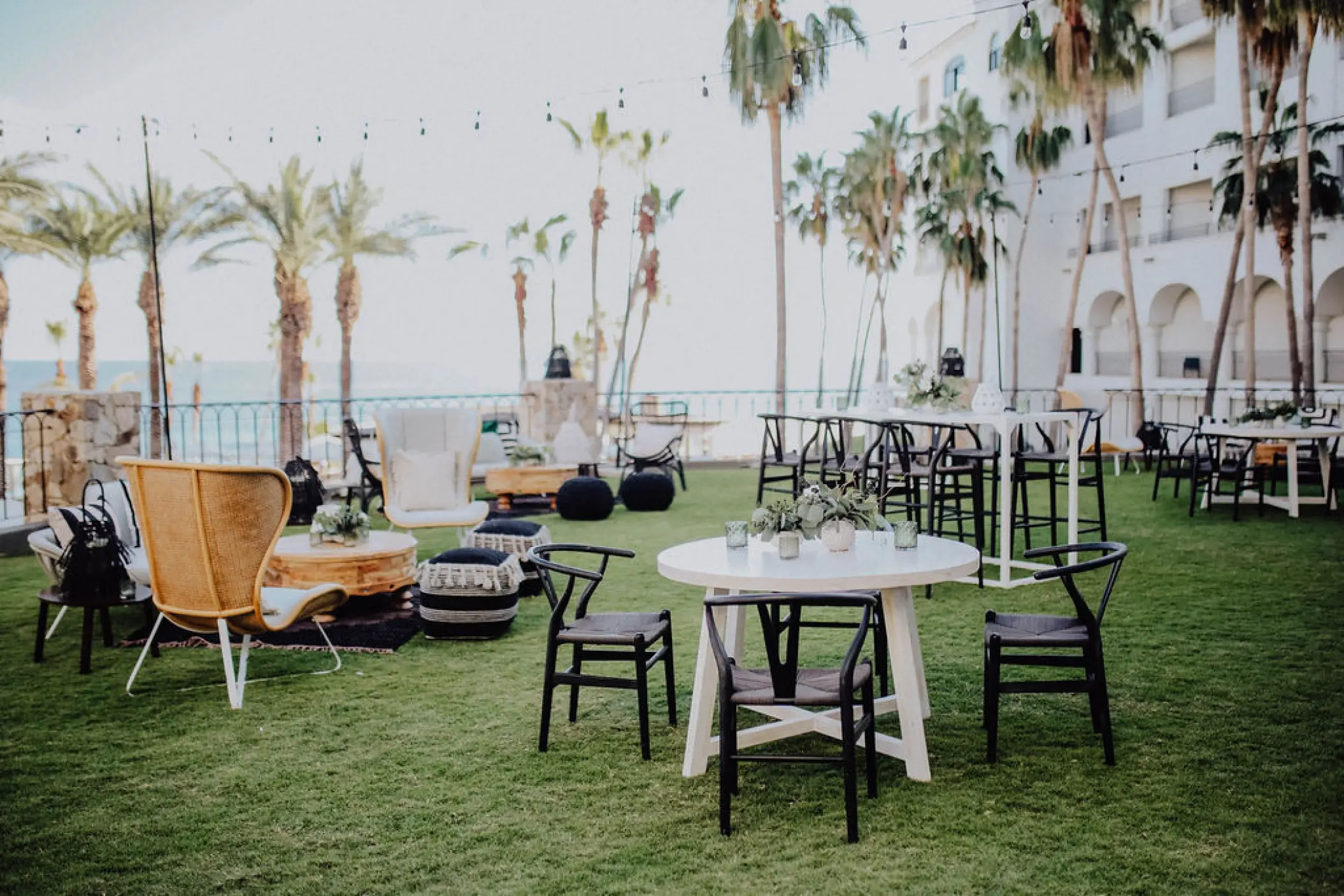 Outdoor cocktail hour lounge and seating on the lawn at Hilton Los Cabos, Cabo San Lucas