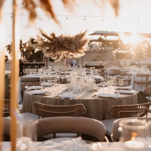 Outdoor wedding reception setup with pampas grass centerpieces at Hilton Los Cabos, Cabo San Lucas