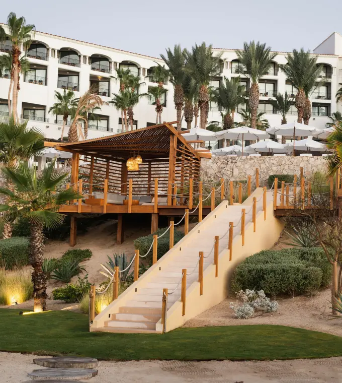 White exterior and wooden terrace at Hilton Los Cabos, Cabo San Lucas