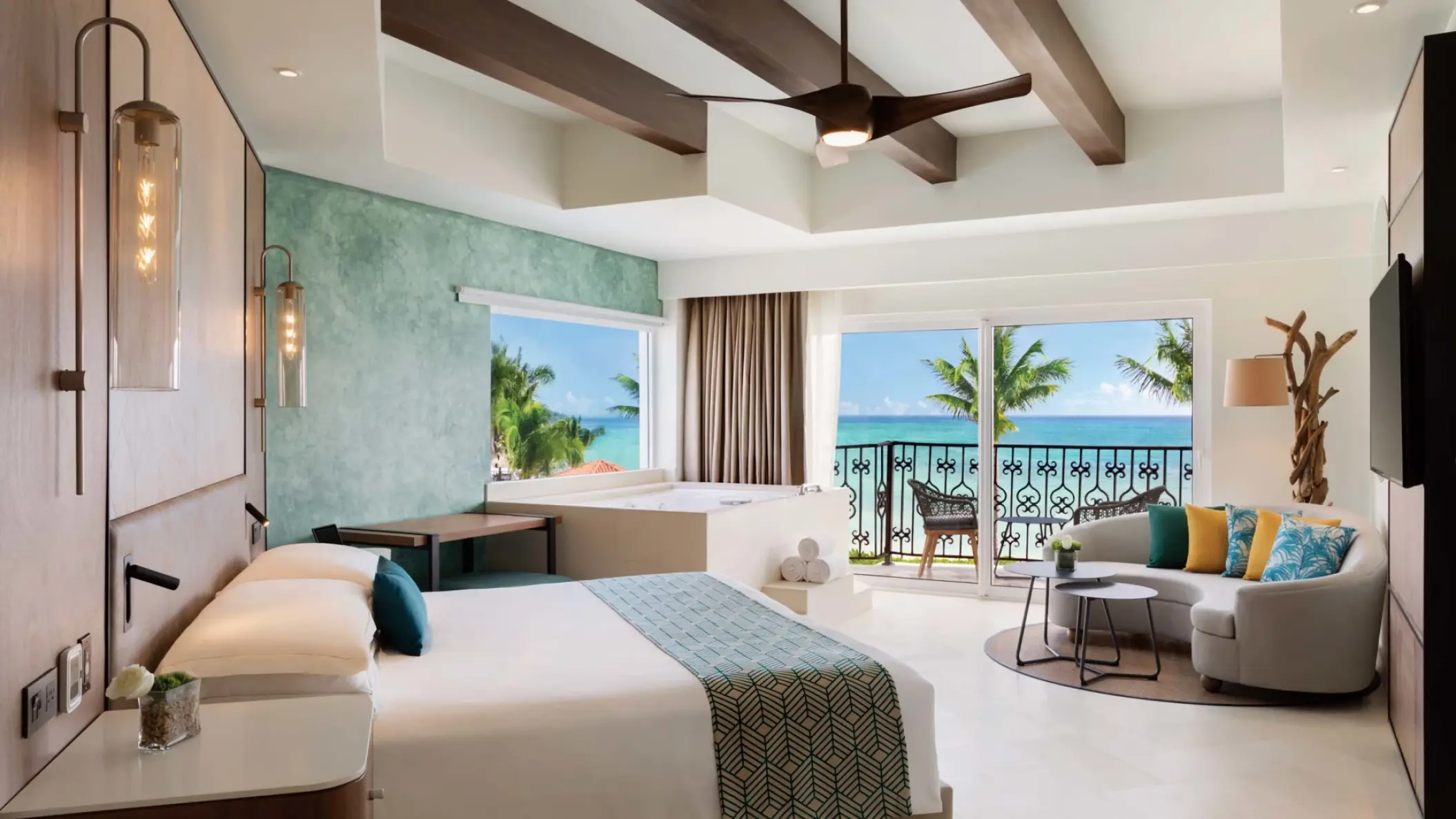 Oceanfront suite with a private balcony and seating area at Hyatt Vivid Playa del Carmen
