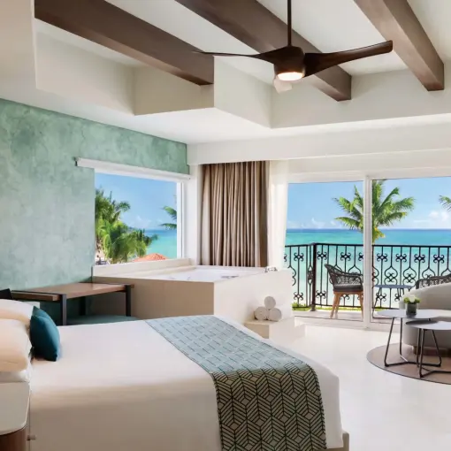 Oceanfront suite with a private balcony and seating area at Hyatt Vivid Playa del Carmen