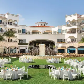 Garden wedding reception with white round tables at Hilton Playa del Carmen, Playa Del Carmen
