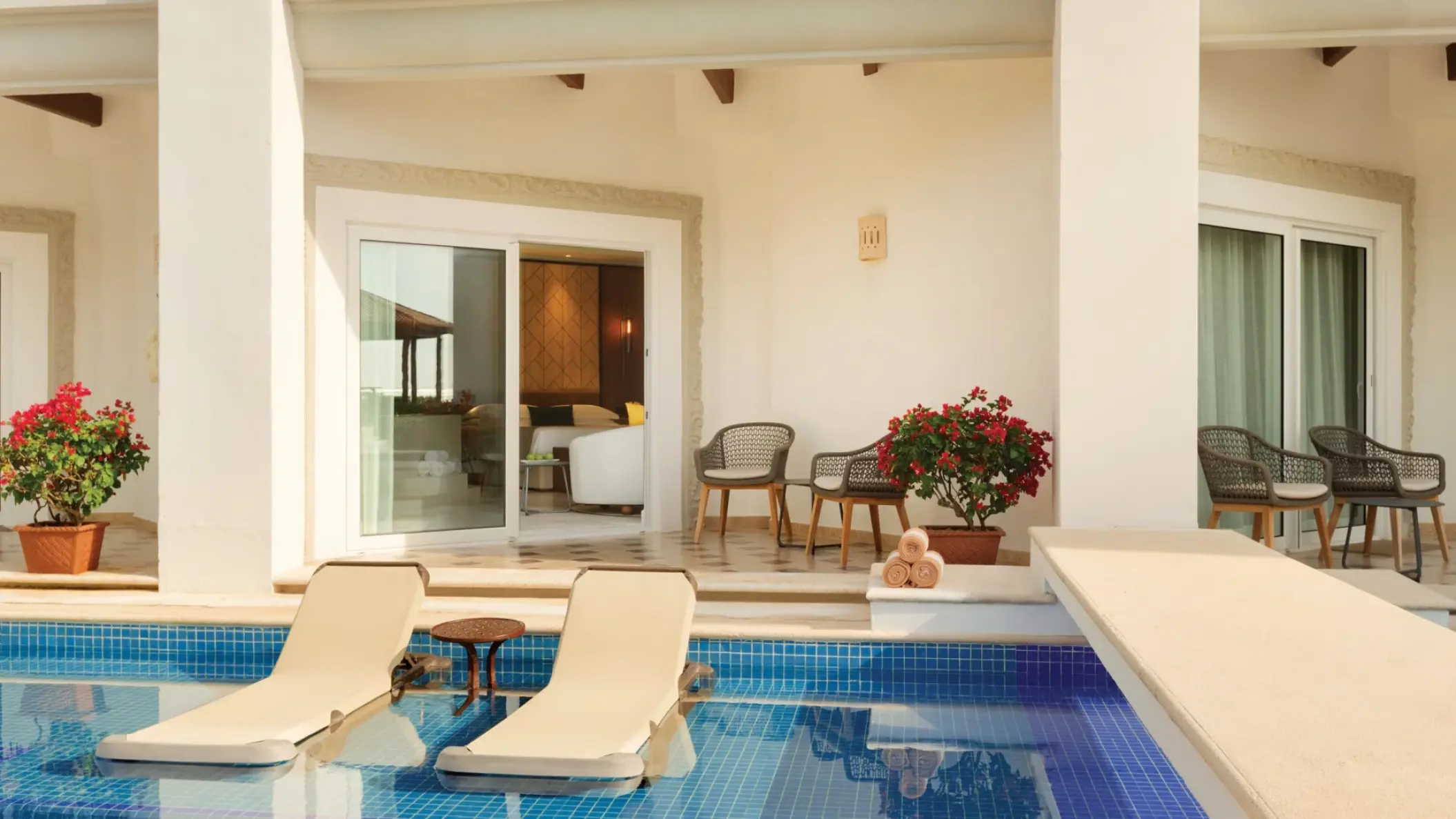 Swim-up junior suite with lounge chairs in the pool at Hilton Playa del Carmen