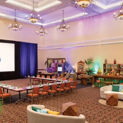 Hilton Playa del Carmen indoor ballroom set for a meeting with a large projector screen and U-shaped seating