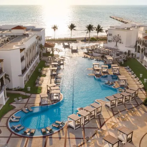 Aerial view of the pool and beachfront suites at Hilton Playa del Carmen
