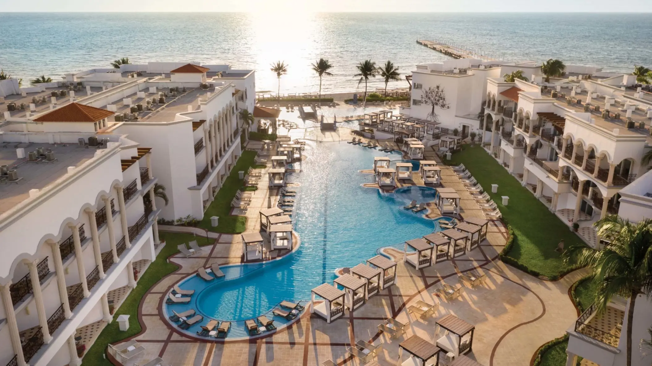 Aerial view of the pool and beachfront suites at Hilton Playa del Carmen