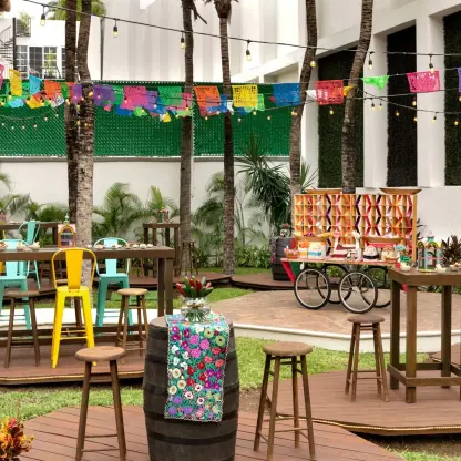 Colorful outdoor reception setup with papel picado banners at Hilton Playa del Carmen