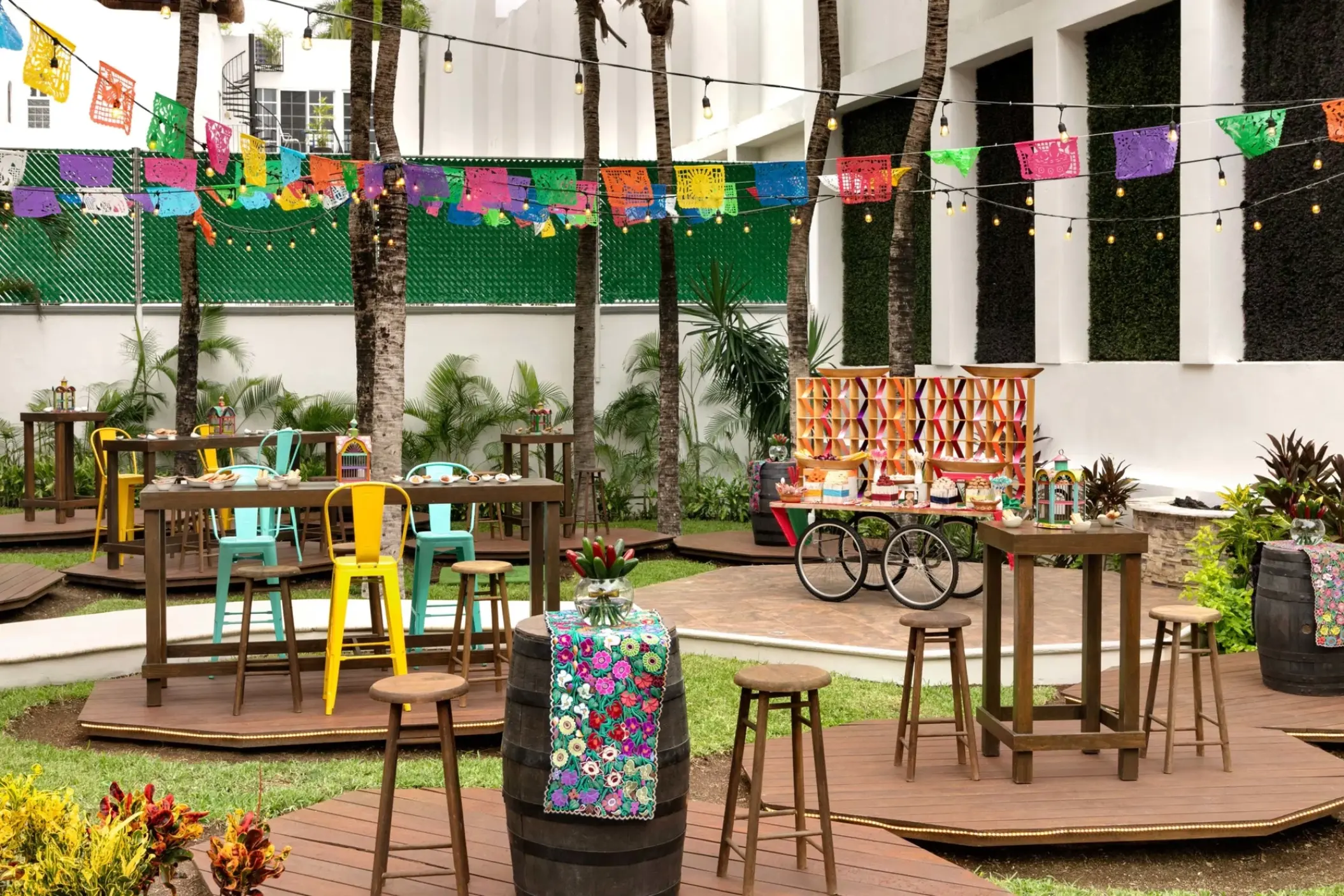 Colorful outdoor reception setup with papel picado banners at Hilton Playa del Carmen