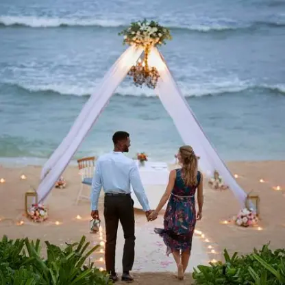 Couple walking toward a private beach dinner setup under a white canopy at Hilton Playa del Carmen