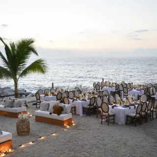 Outdoor beach wedding reception with white linens and lounge seating at Hilton Vallarta Riviera, Puerto Vallarta