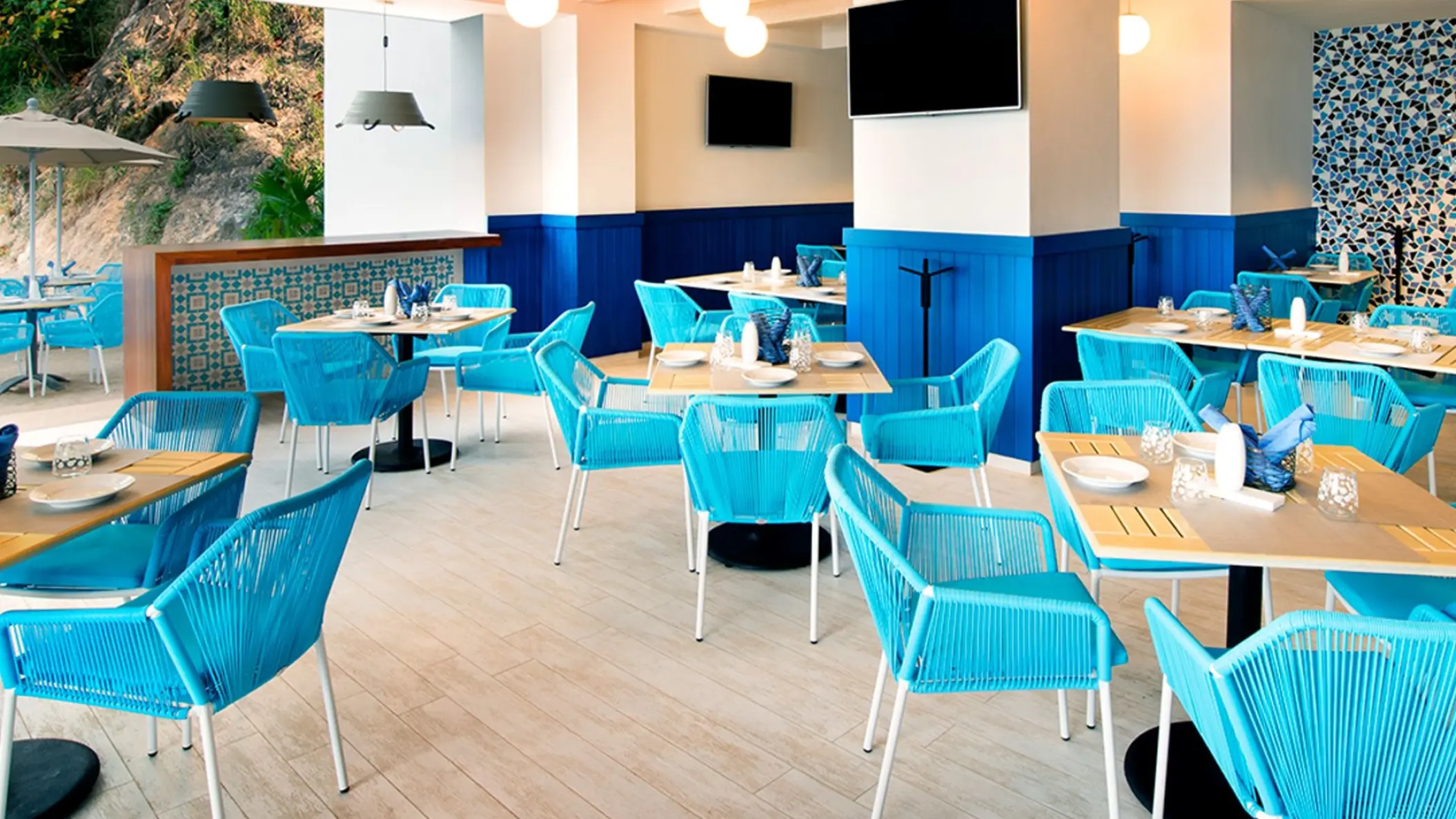 Cevicheria restaurant with blue chairs and white tables at Hilton Vallarta Riviera, Puerto Vallarta