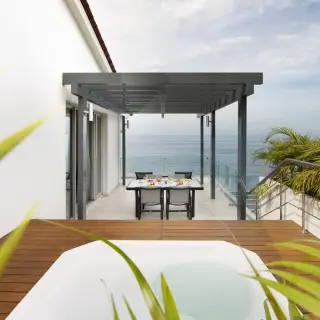 Private terrace with a whirlpool and dining table overlooking the ocean at Hilton Vallarta Riviera, Puerto Vallarta