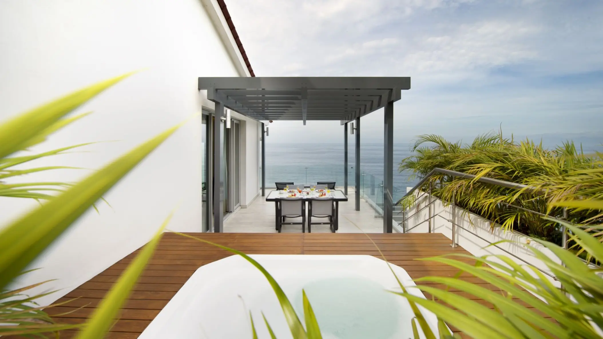Private terrace with a whirlpool and dining table overlooking the ocean at Hilton Vallarta Riviera, Puerto Vallarta