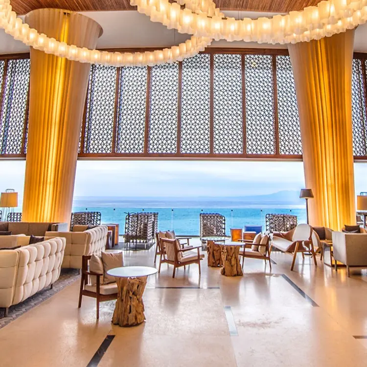 Hilton Vallarta Riviera open-air lobby with ocean views and modern seating, Puerto Vallarta