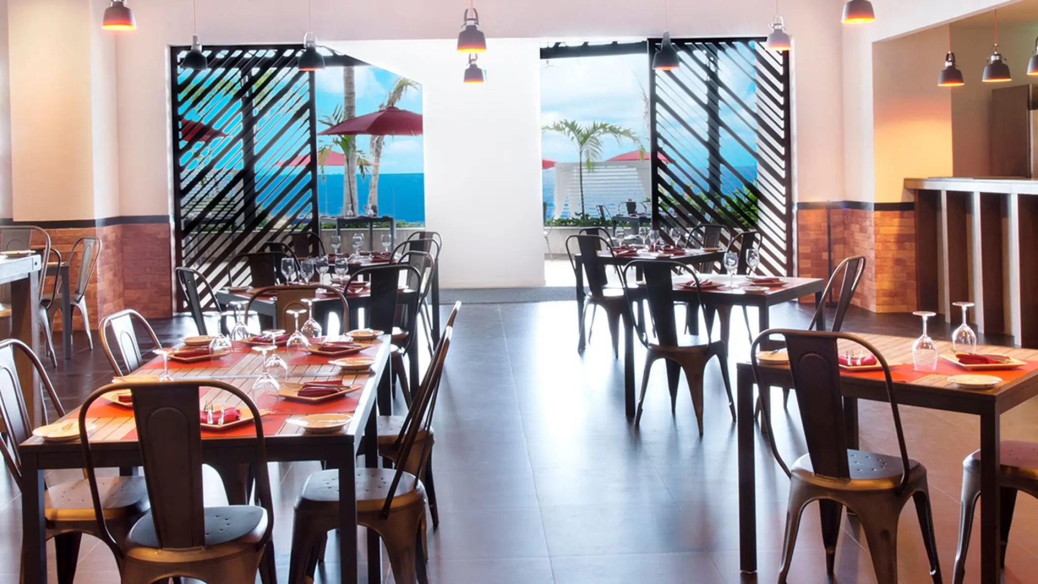 Indoor seating at the Shore Grill with ocean views at Hilton Vallarta Riviera, Puerto Vallarta