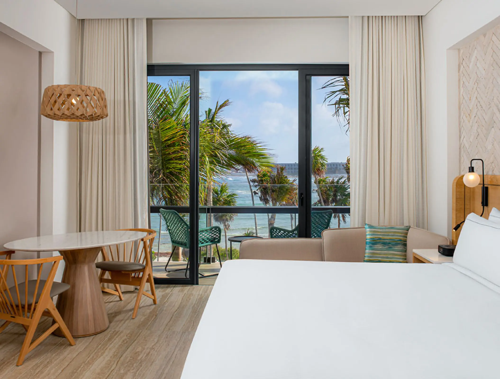 Hilton Tulum suite interior with ocean views from the balcony, Tulum