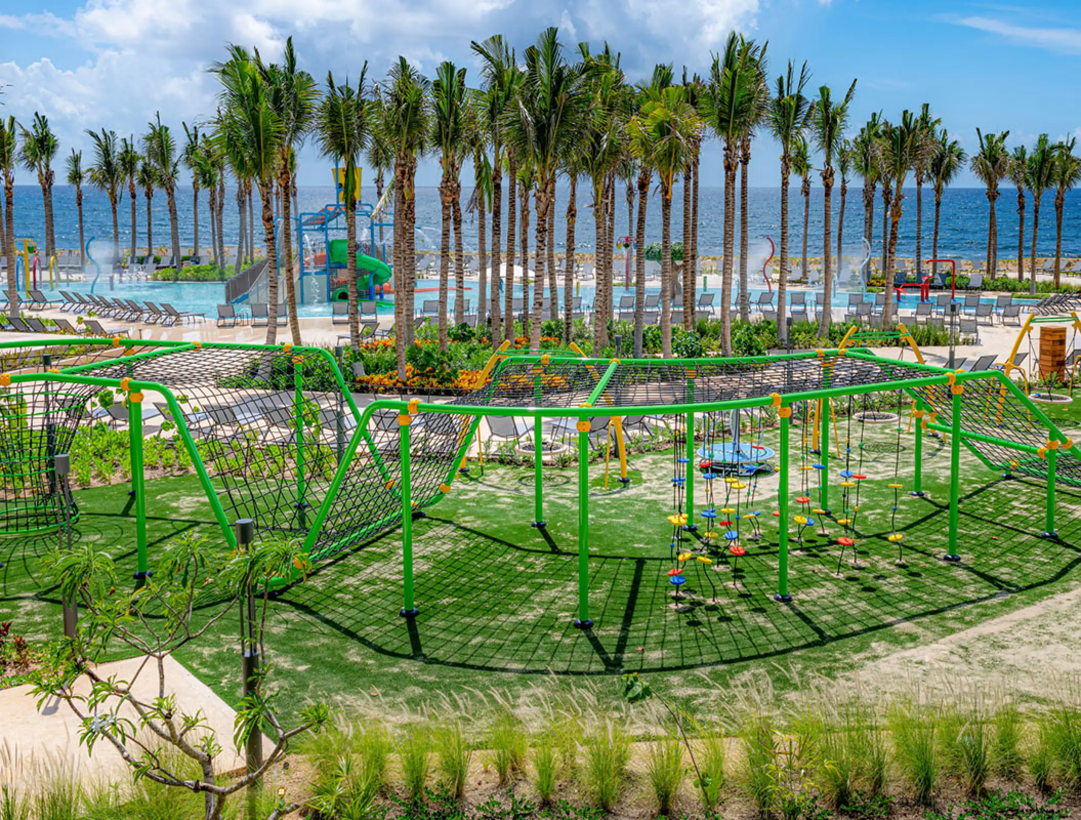 Green outdoor play area and kids zone at Hilton Tulum