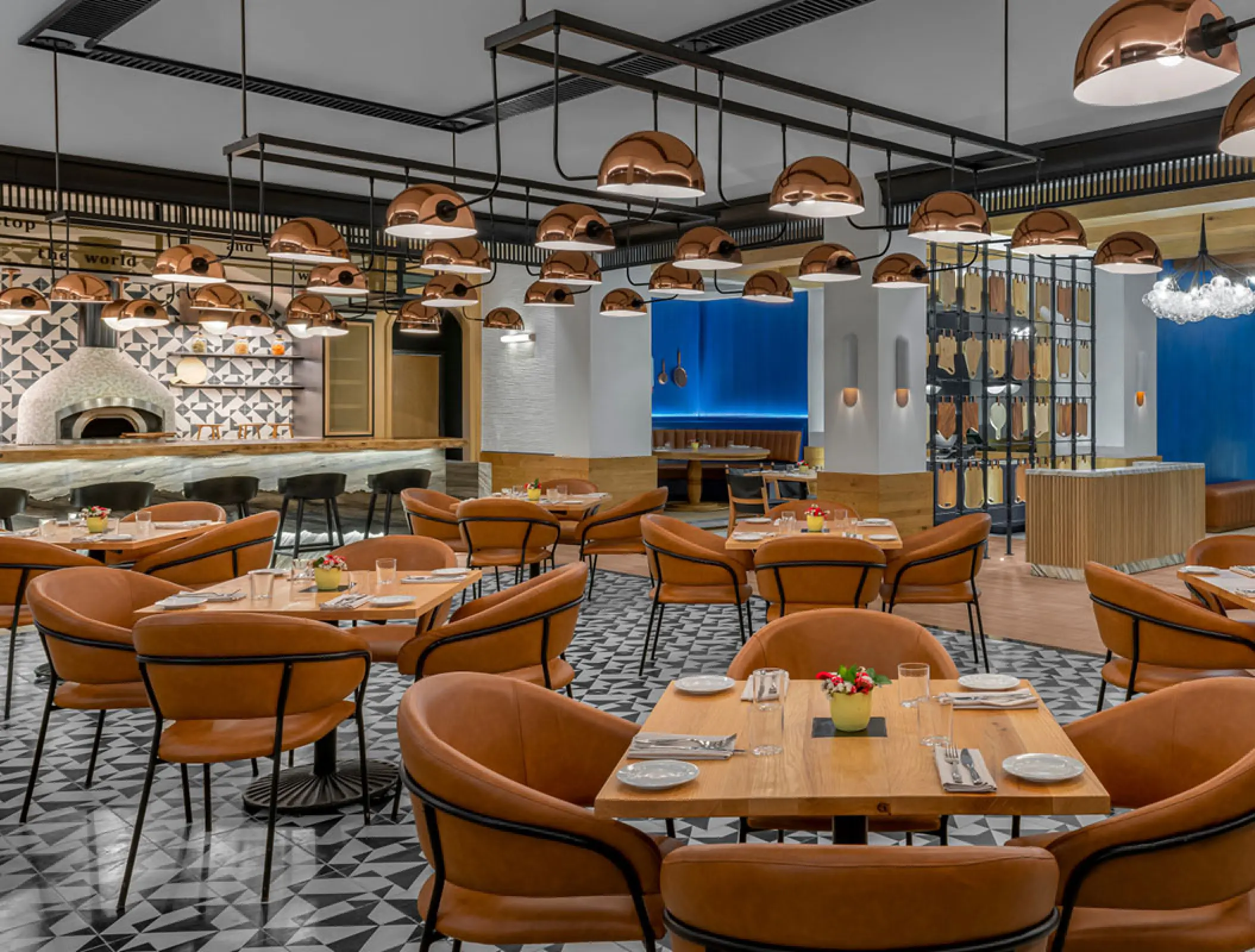 Modern restaurant dining room with copper pendant lights at Hilton Tulum