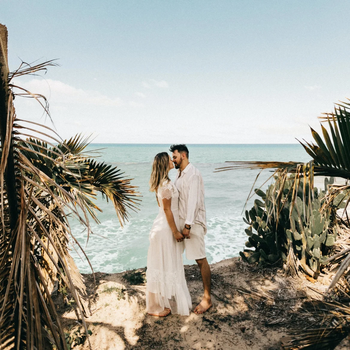 Couple getting married on the beach with boho vibe
