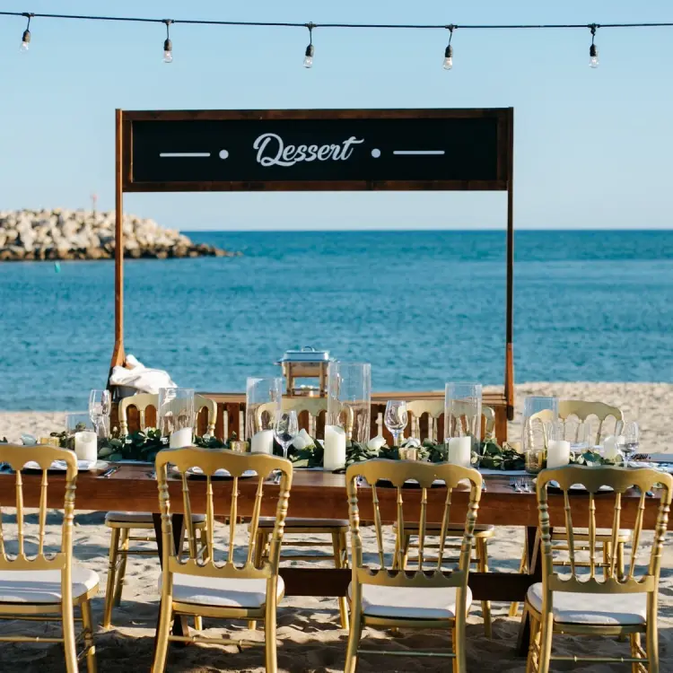 Beachfront wedding reception table with gold chairs at Hotel El Ganzo, Cabo San Lucas