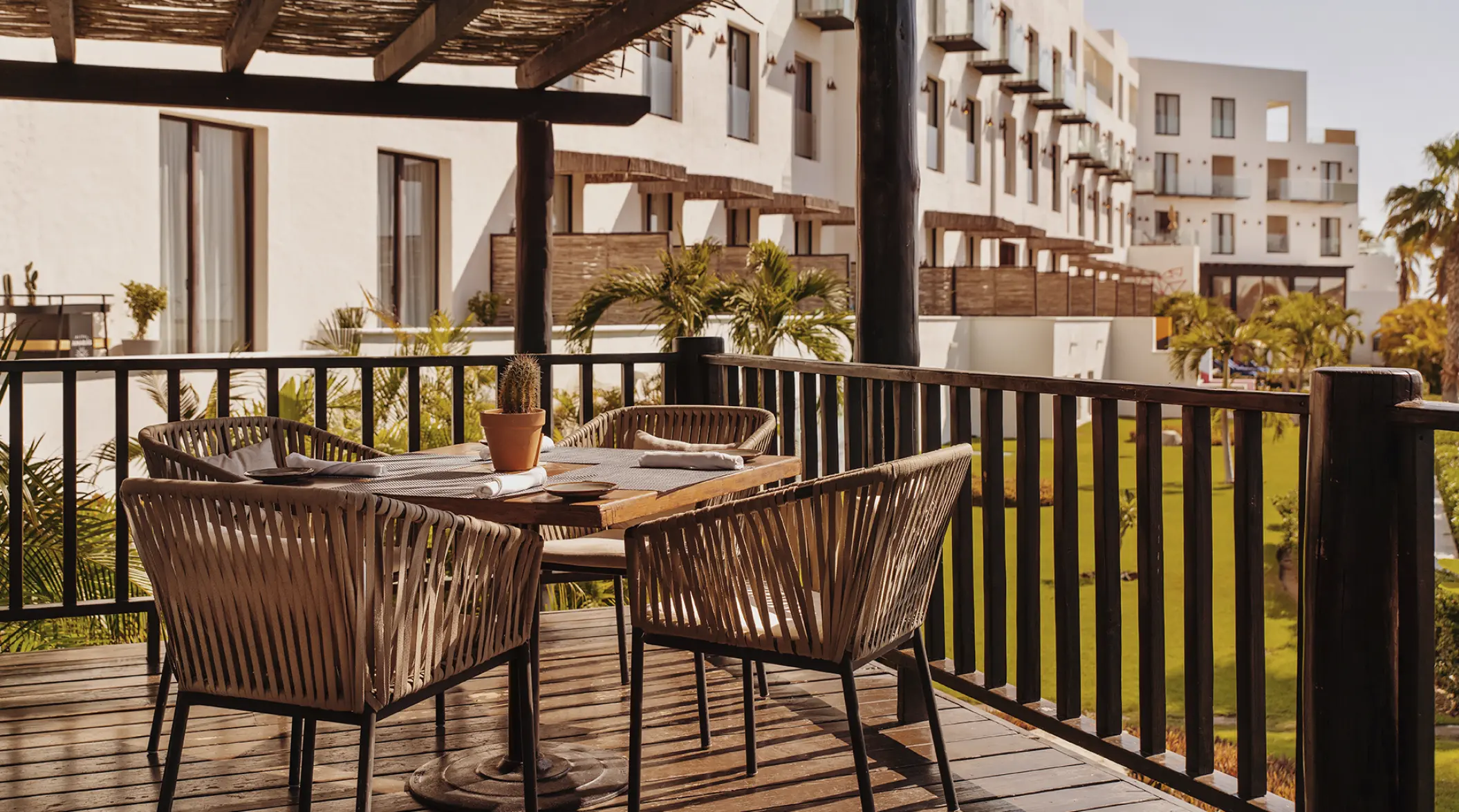 Outdoor restaurant terrace with woven chairs at Hotel El Ganzo, Cabo San Lucas