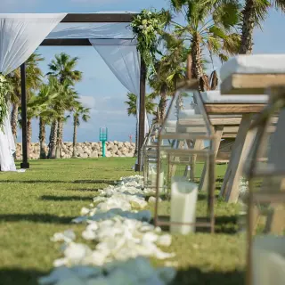 Outdoor wedding ceremony setup with flower petals and lanterns on the lawn at Hotel El Ganzo, Cabo San Lucas