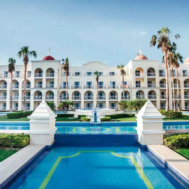 White arched facade and reflection pools at Riu Palace Cabo San Lucas