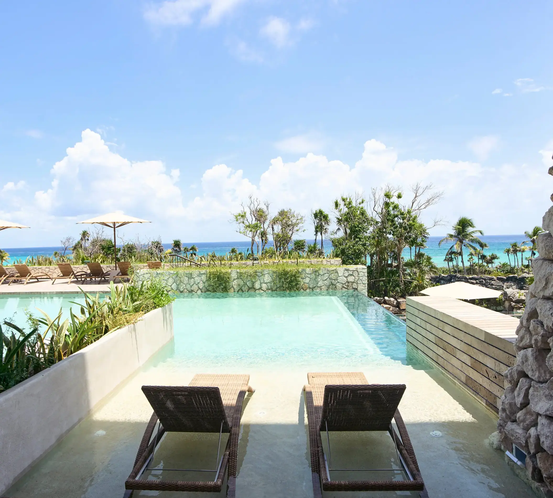 Hotel Xcaret Arte swim-up suite with lounge chairs and ocean views, Riviera Maya