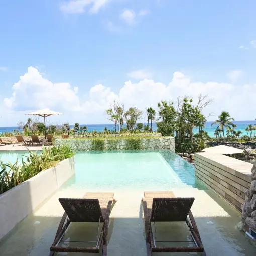 Hotel Xcaret Arte swim-up suite with lounge chairs and ocean views, Riviera Maya