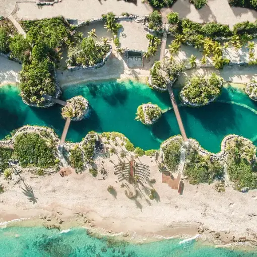 Aerial view of turquoise lagoons and bridges at Hotel Xcaret Arte, Riviera Maya