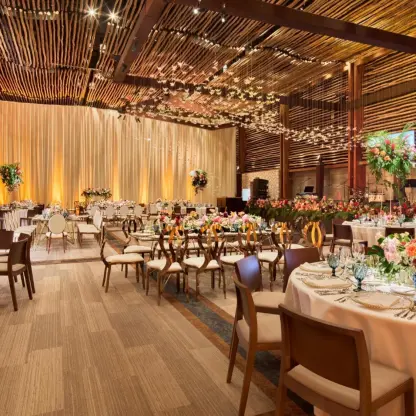 Frida Ballroom wedding reception with wooden accents and floral centerpieces at Hotel Xcaret Arte, Riviera Maya