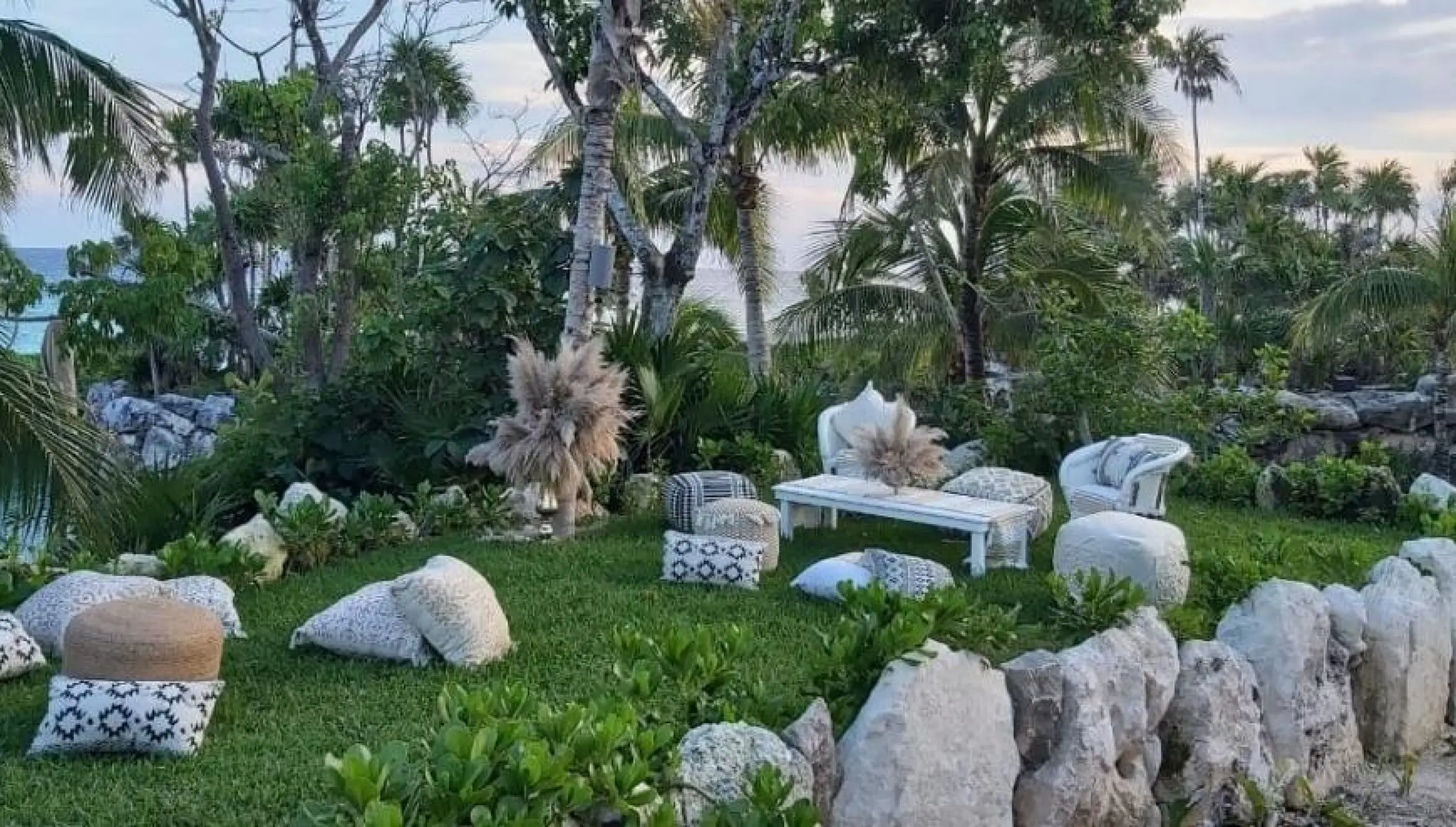 Garden wedding reception lounge area with floor cushions at Hotel Xcaret Arte, Riviera Maya
