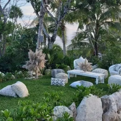 Garden wedding reception lounge area with floor cushions at Hotel Xcaret Arte, Riviera Maya