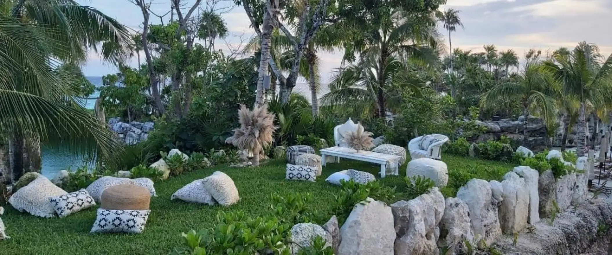 Garden wedding reception lounge area with floor cushions at Hotel Xcaret Arte, Riviera Maya