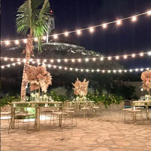 Evening wedding reception under string lights at Hotel Xcaret Arte, Riviera Maya