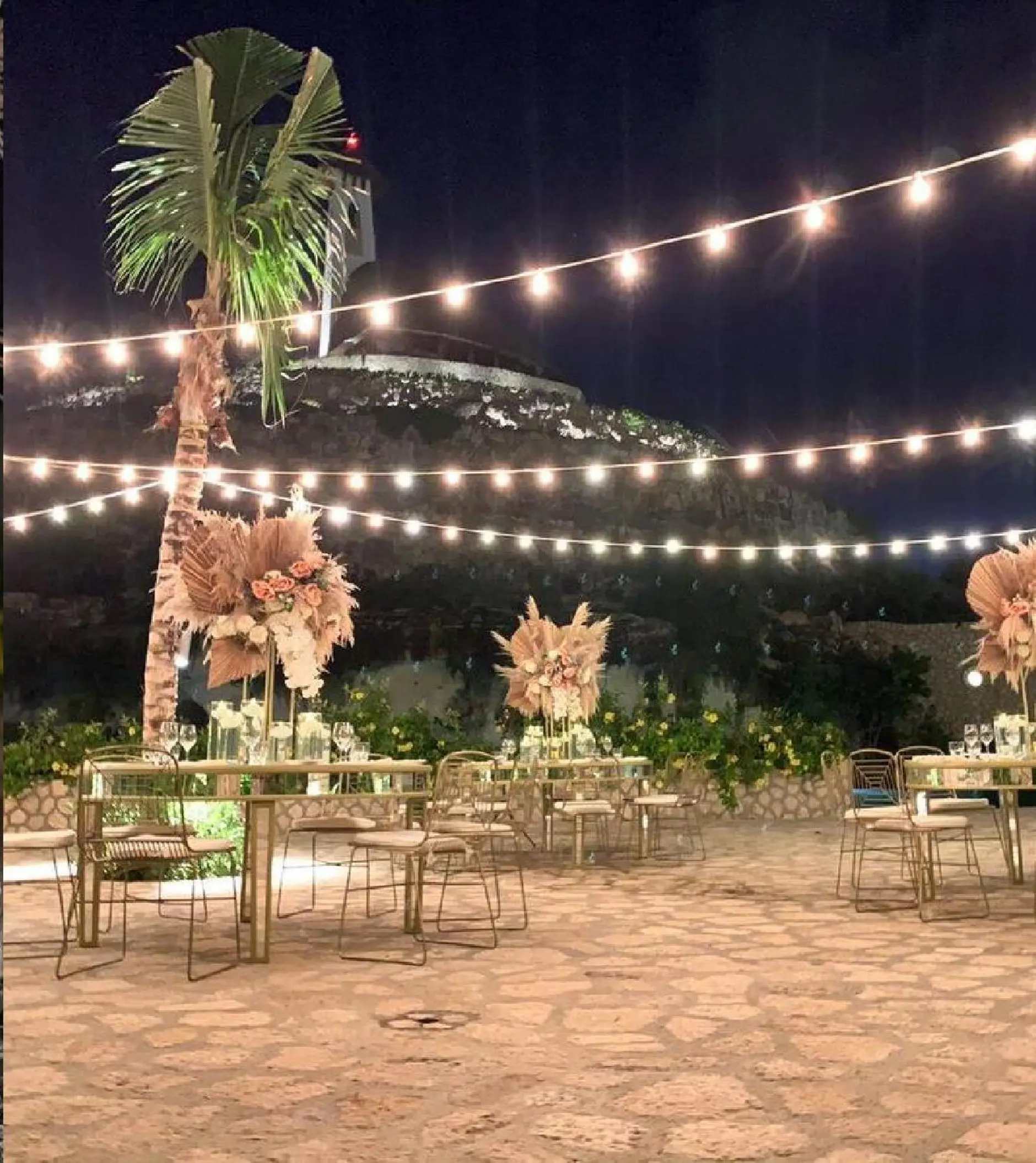 Evening wedding reception under string lights at Hotel Xcaret Arte, Riviera Maya