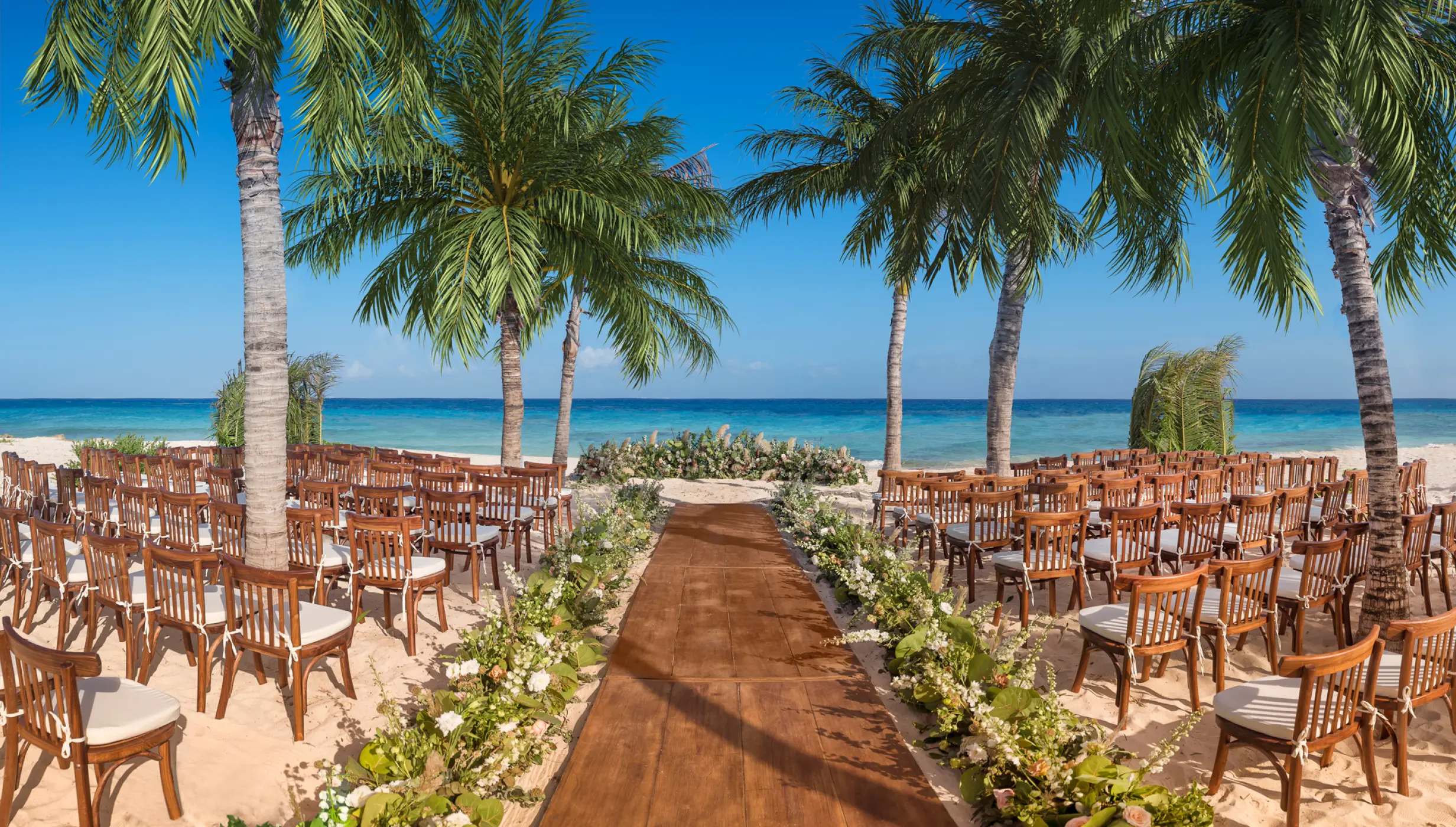beach wedding venue with chairs at Hotel Xcaret Mexico