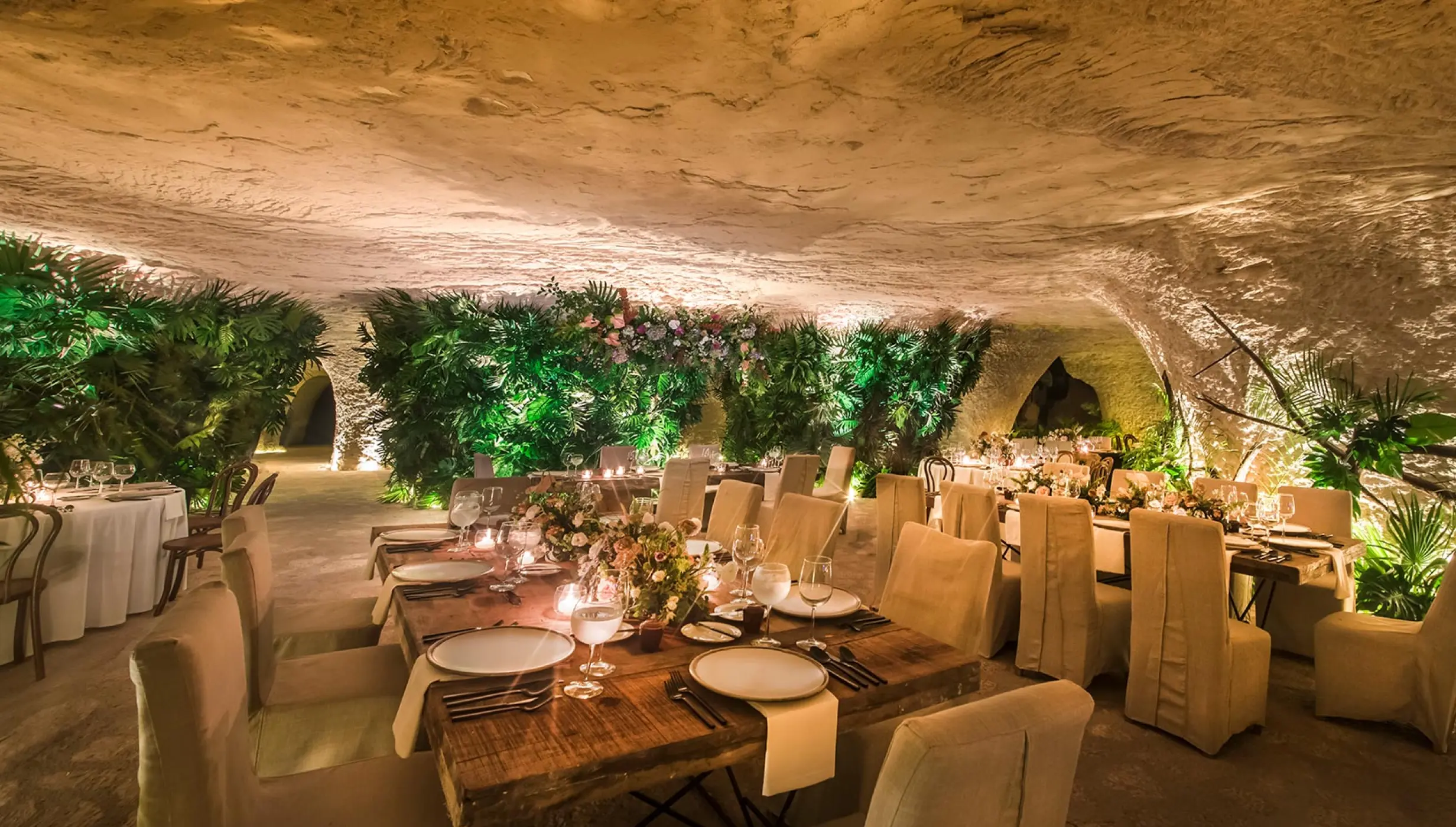 wedding venue reception in caves with tables and chairs at Hotel Xcaret Mexico