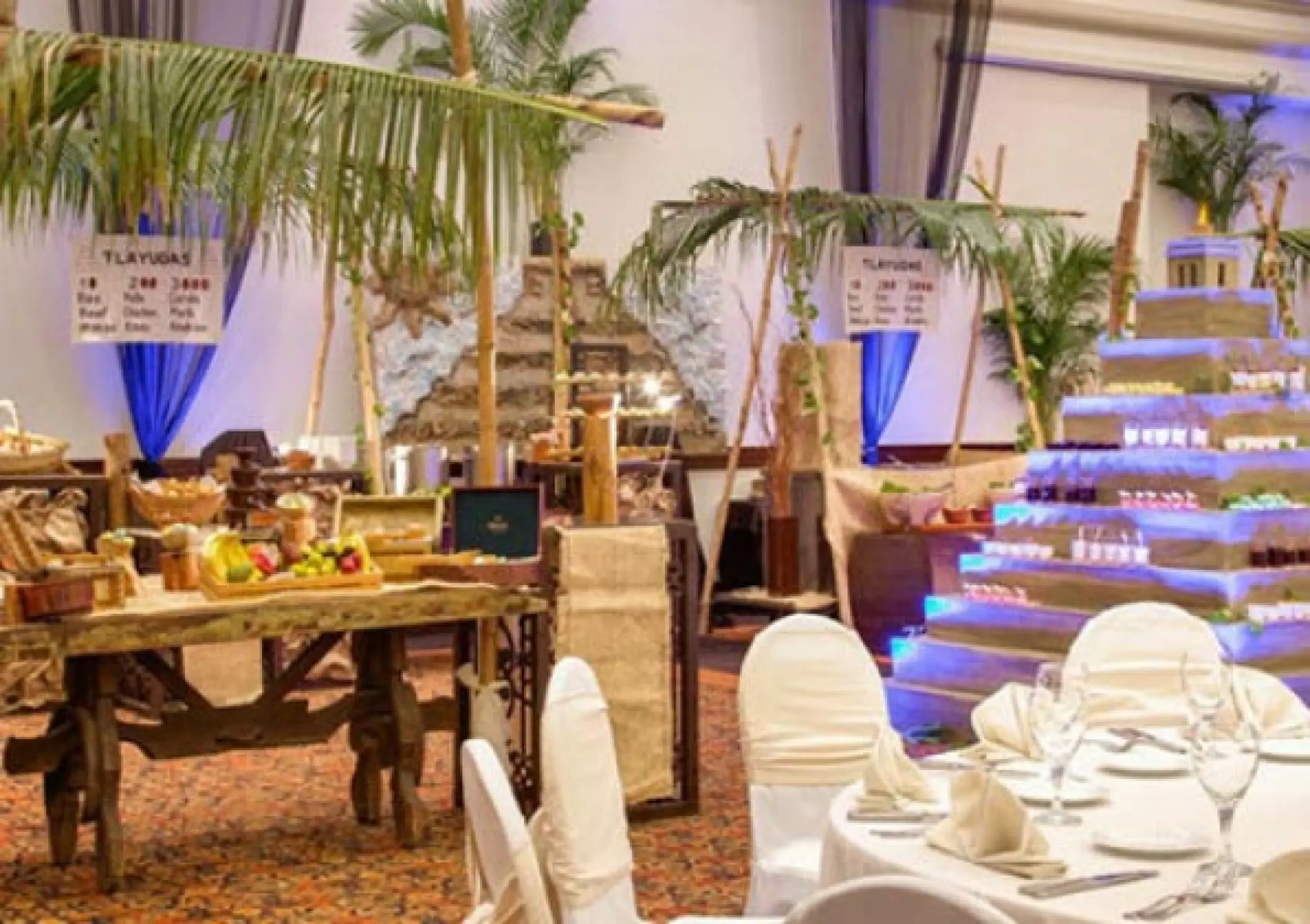 Indoor wedding reception with a tropical food display at Hyatt Zilara Cancun