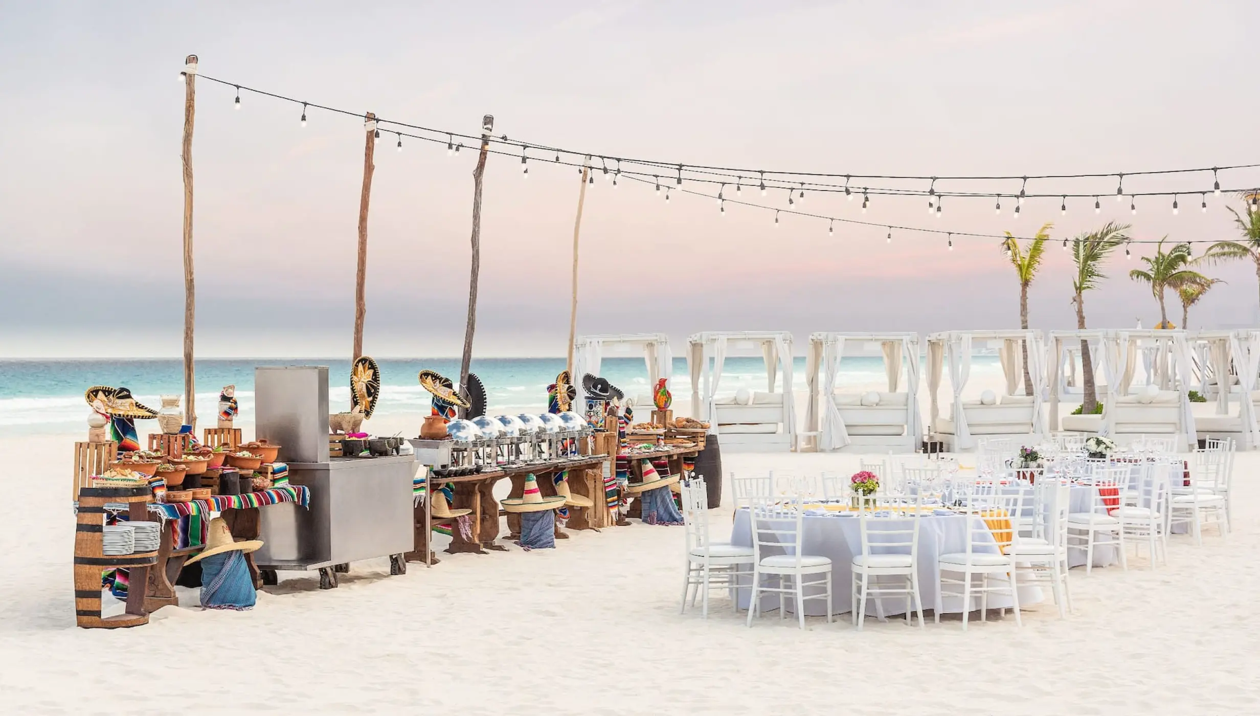 Beachfront wedding reception setup with white tables and catering at Hyatt Zilara Cancun, Cancun