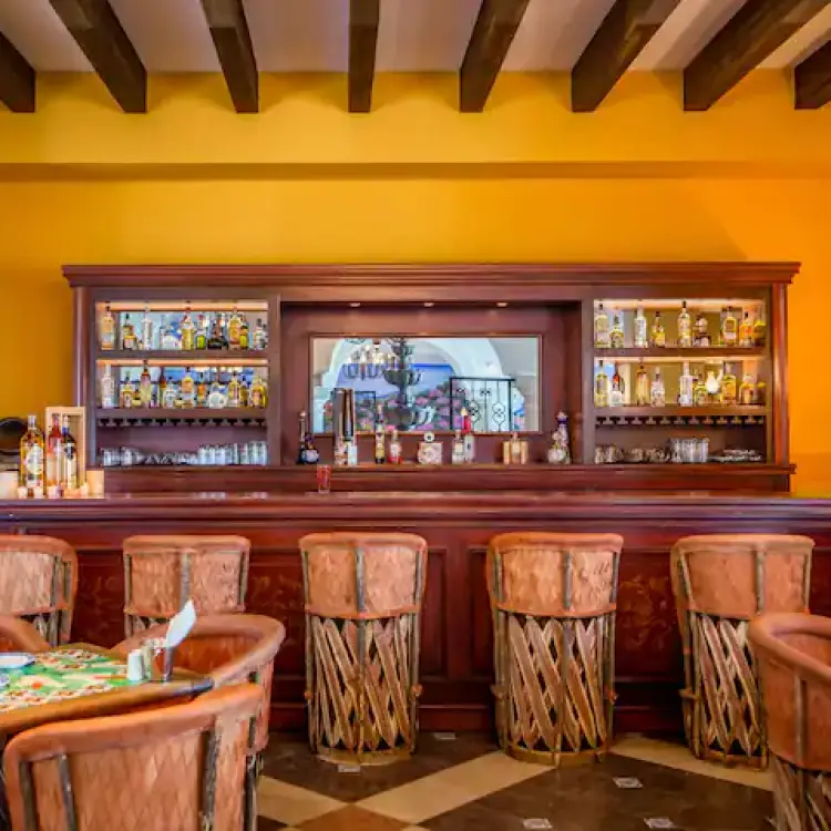 Cantina La Adelita bar with traditional wooden seating at Hyatt Zilara Cancun