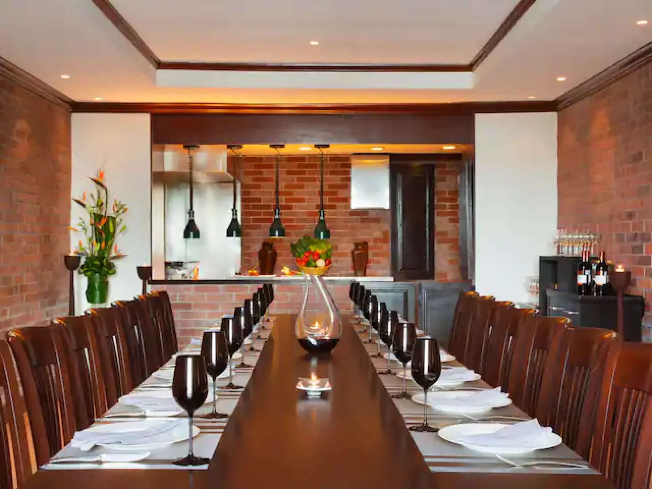 Chef’s Plate private dining room with a long table and brick walls at Hyatt Zilara Cancun