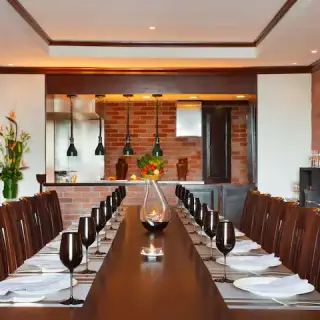 Chef’s Plate private dining room with a long table and brick walls at Hyatt Zilara Cancun