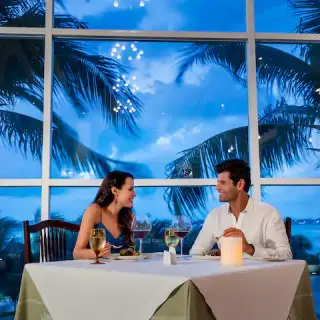 Couple sharing a romantic dinner at Hyatt Zilara Cancun