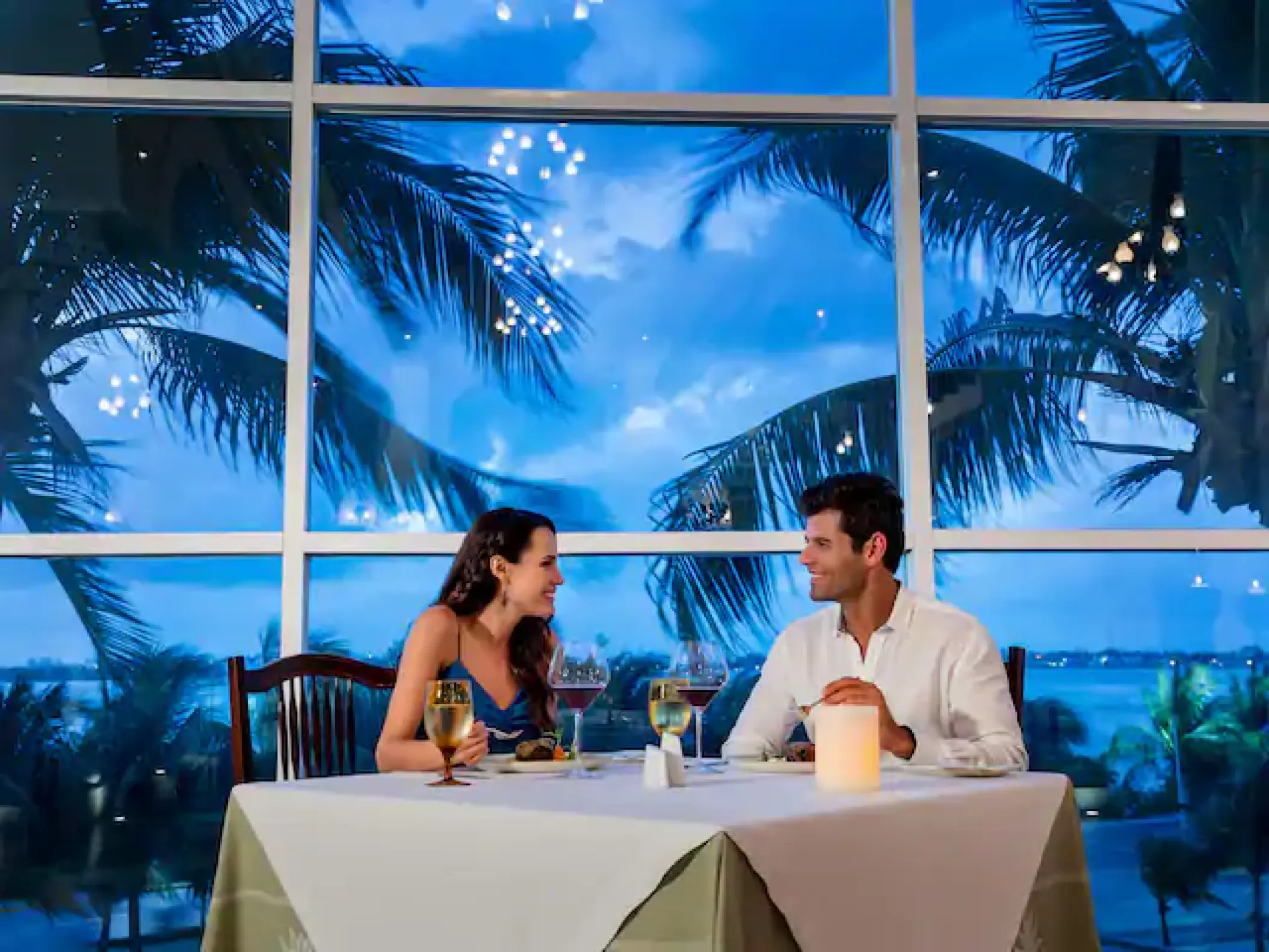 Couple sharing a romantic dinner at Hyatt Zilara Cancun