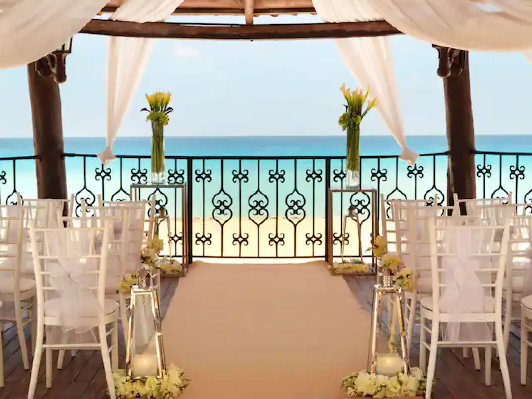 Wedding ceremony setup under a wooden gazebo with ocean views at Hyatt Zilara, Cancun
