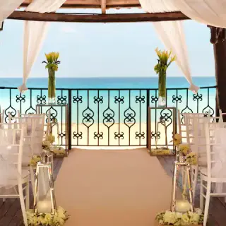 Wedding ceremony setup under a wooden gazebo with ocean views at Hyatt Zilara, Cancun