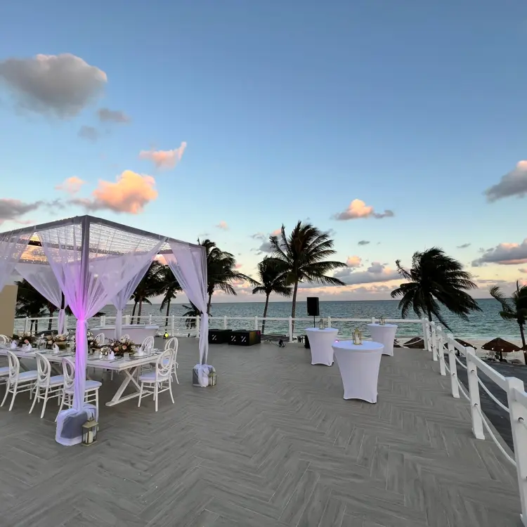 Rooftop wedding reception with a white canopy and dining table at Hyatt Zilara Riviera Maya