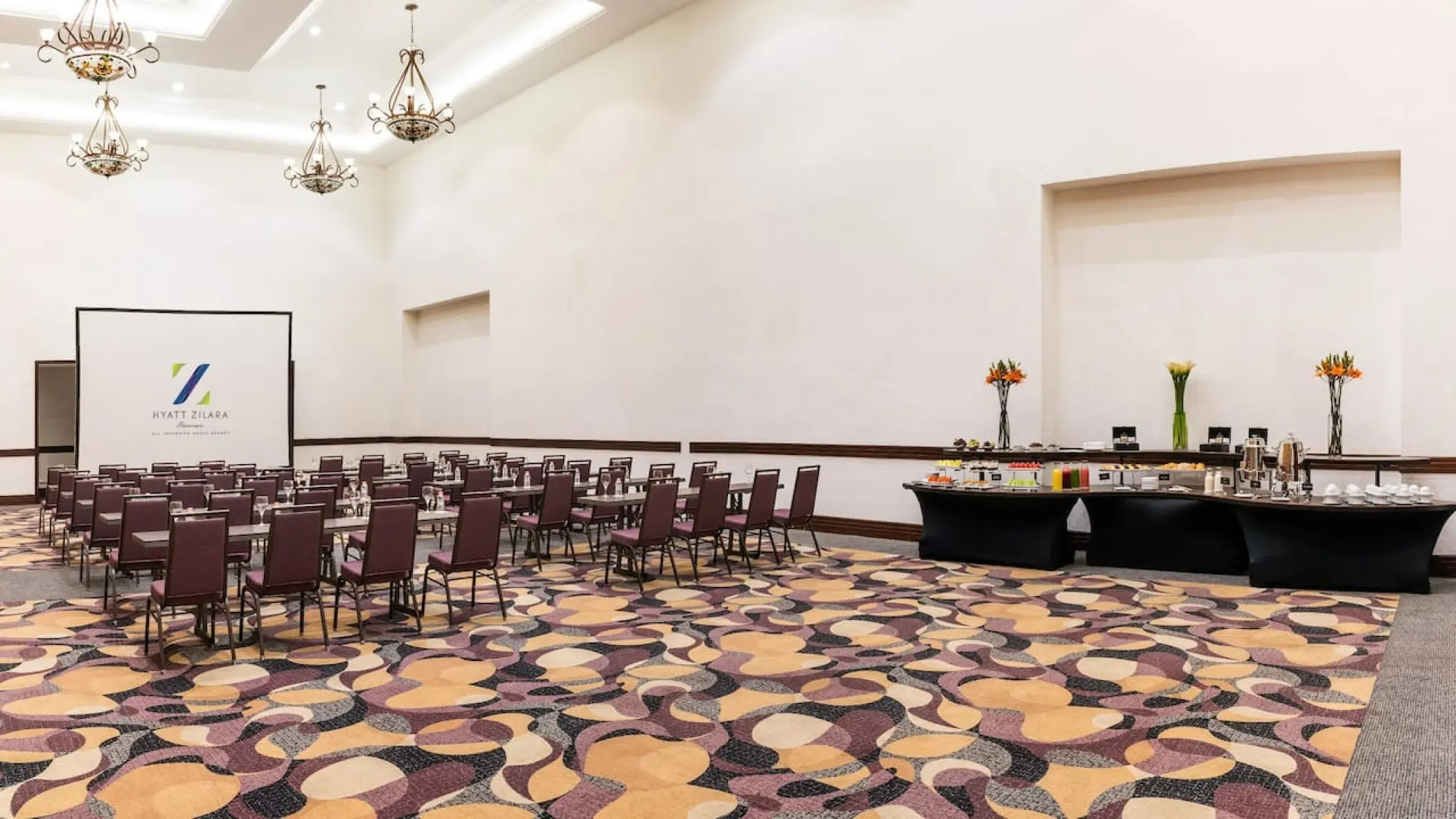 Zilara Ballroom wedding reception setup with chandeliers and buffet station at Hyatt Zilara Cancun